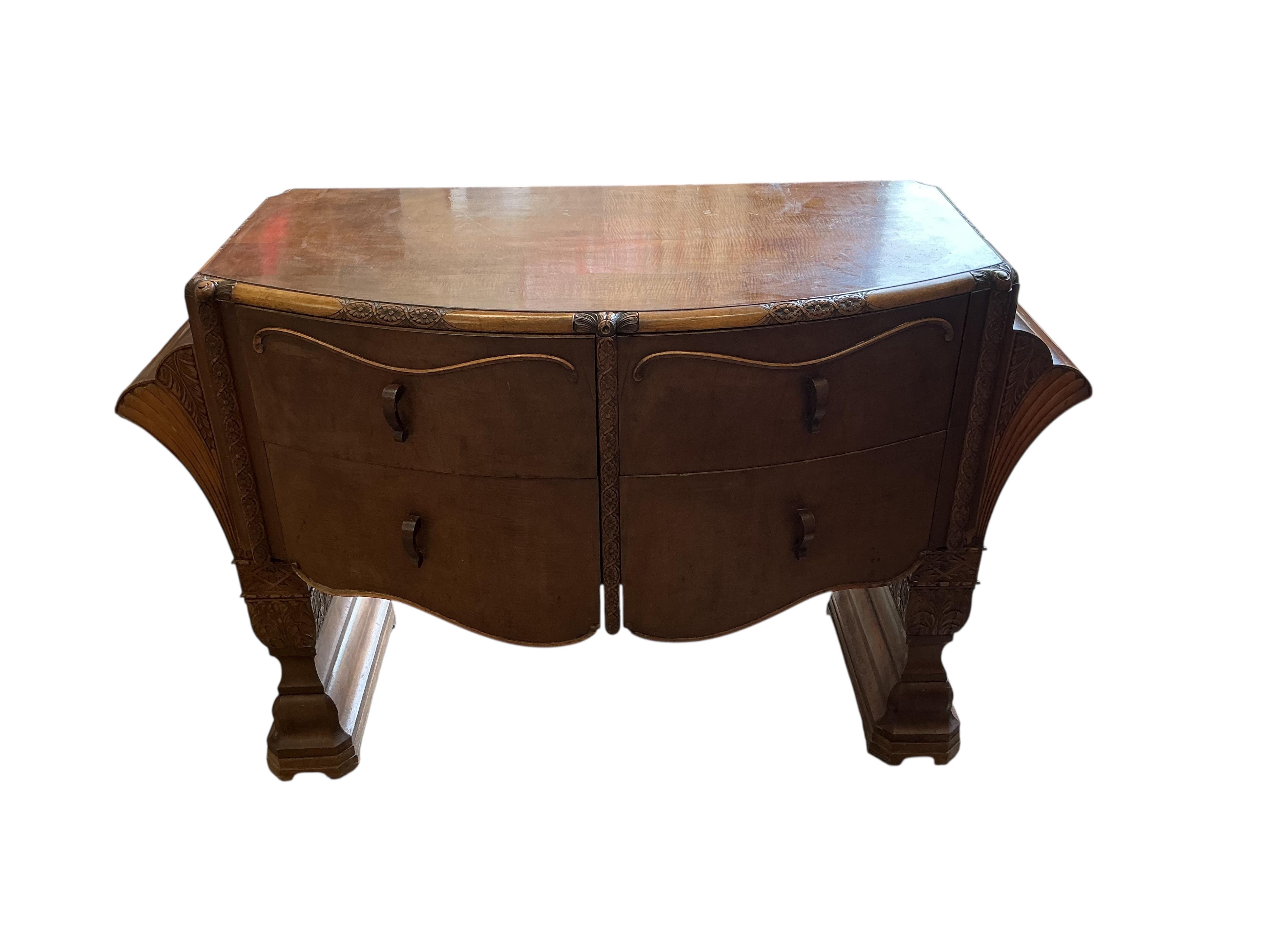 An Art deco walnut dining suite, comprising: dining table, width 190cm, depth 110cm, height 80cm together with eight chairs (two being carvers) and a bow front sideboard
